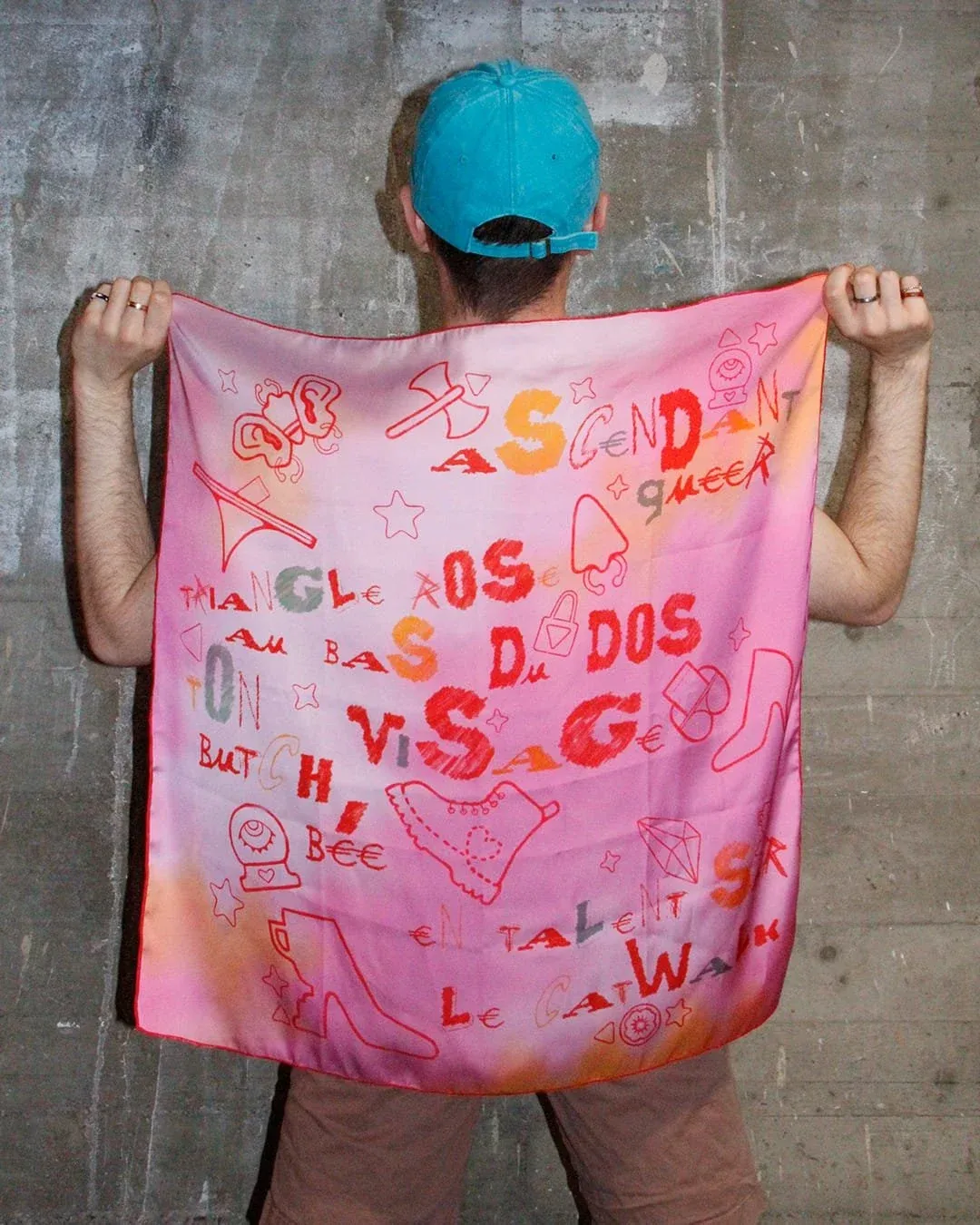 The Collectif Badaboum Ascendant Queer scarf, held out at arm’s length.